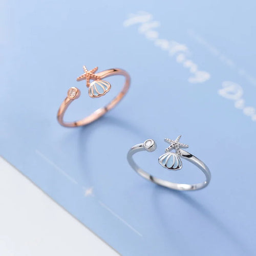 Sõrmus merekarpide, meritähe ja Jakobimaja kestaga ning roosakuldse tsirkooniga