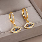 Boucles d'oreilles créoles avec pendentif oeil bleu orné de strass