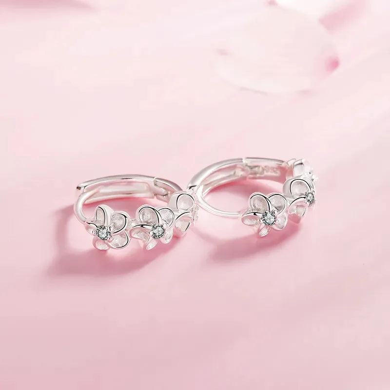 Hoop earrings with trio of flowers