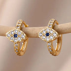 Boucles d'oreilles créoles oeil bleu incrusté de strass