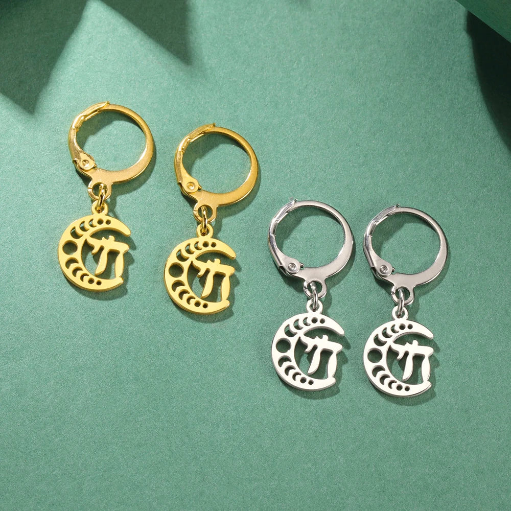 Dangling earrings with the Chai life symbol on a gold crescent moon