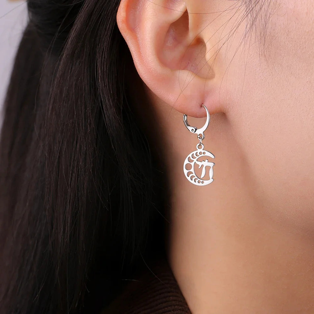Dangling earrings with the Chai life symbol on a silver crescent moon