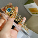 Boucles d'Oreilles Pendantes Oeil Bleu et Strass