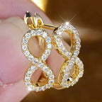 Boucles d'oreilles pendantes symbole infini scintillant or