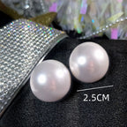 Giant button pearl earrings