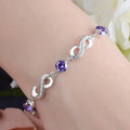 Bracelet avec perles violettes et symboles infinis ornés de cristaux 