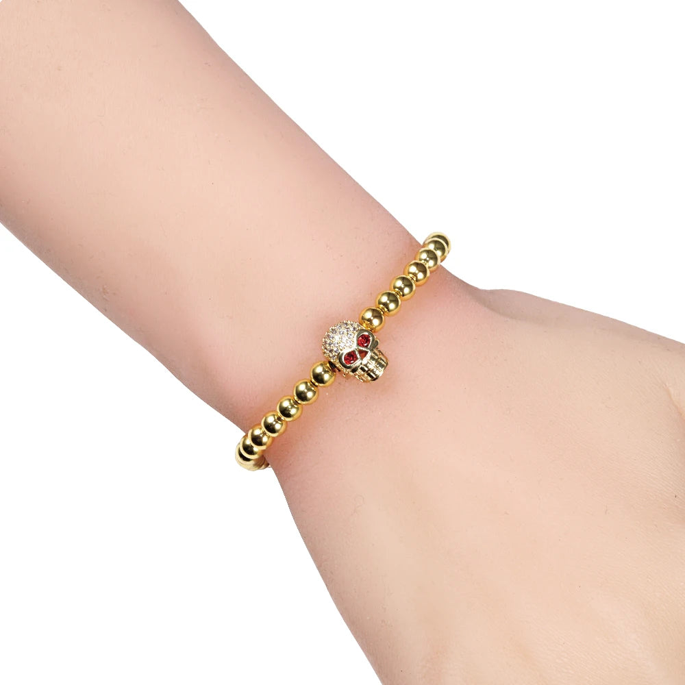 Pulseira de cordão com contas e caveira em strass místico dourado