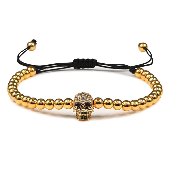 Pulseira de cordão com contas e caveira em strass místico dourado
