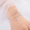 Bracelet doré avec petite breloque spirale argent