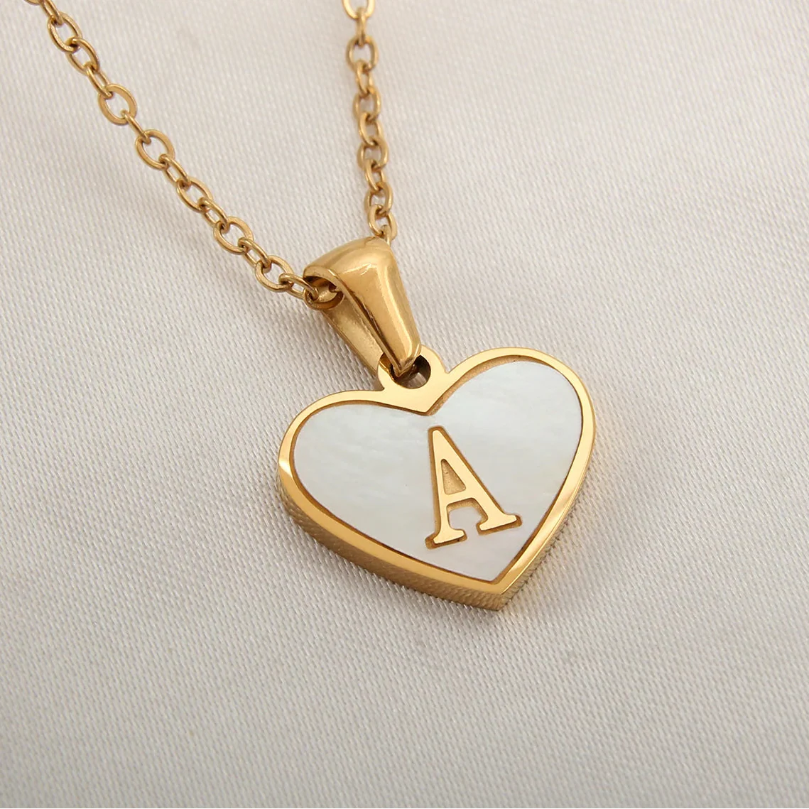 Necklace with white heart pendant initial a
