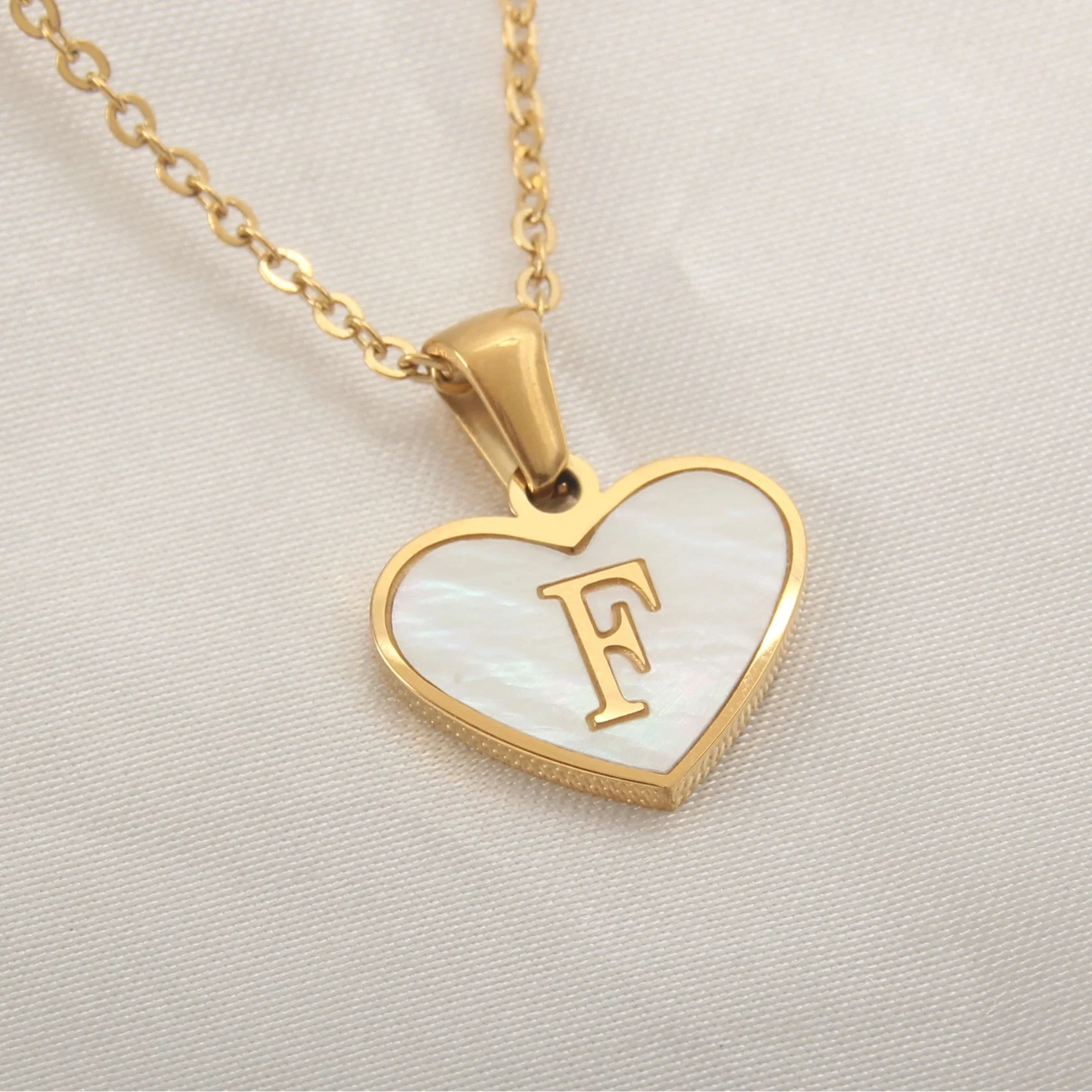 Necklace with white heart pendant initial f