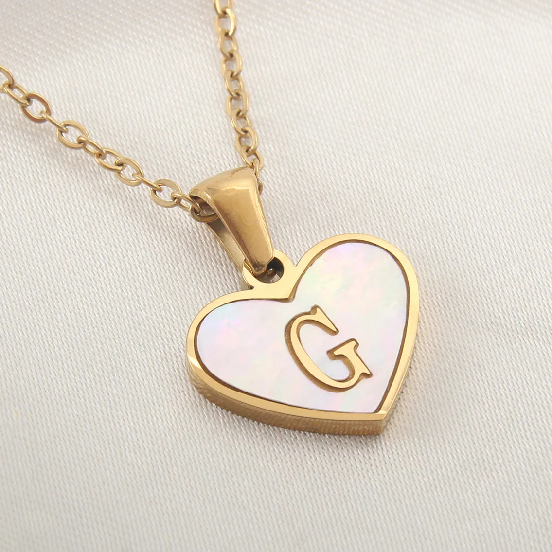 Necklace with white heart pendant initial g