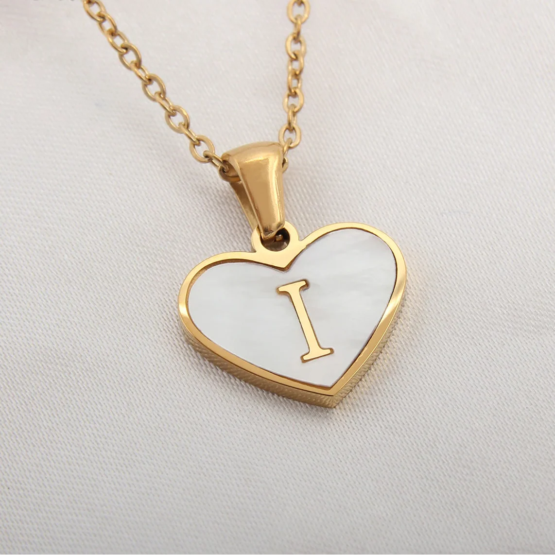 Necklace with white heart pendant initial i
