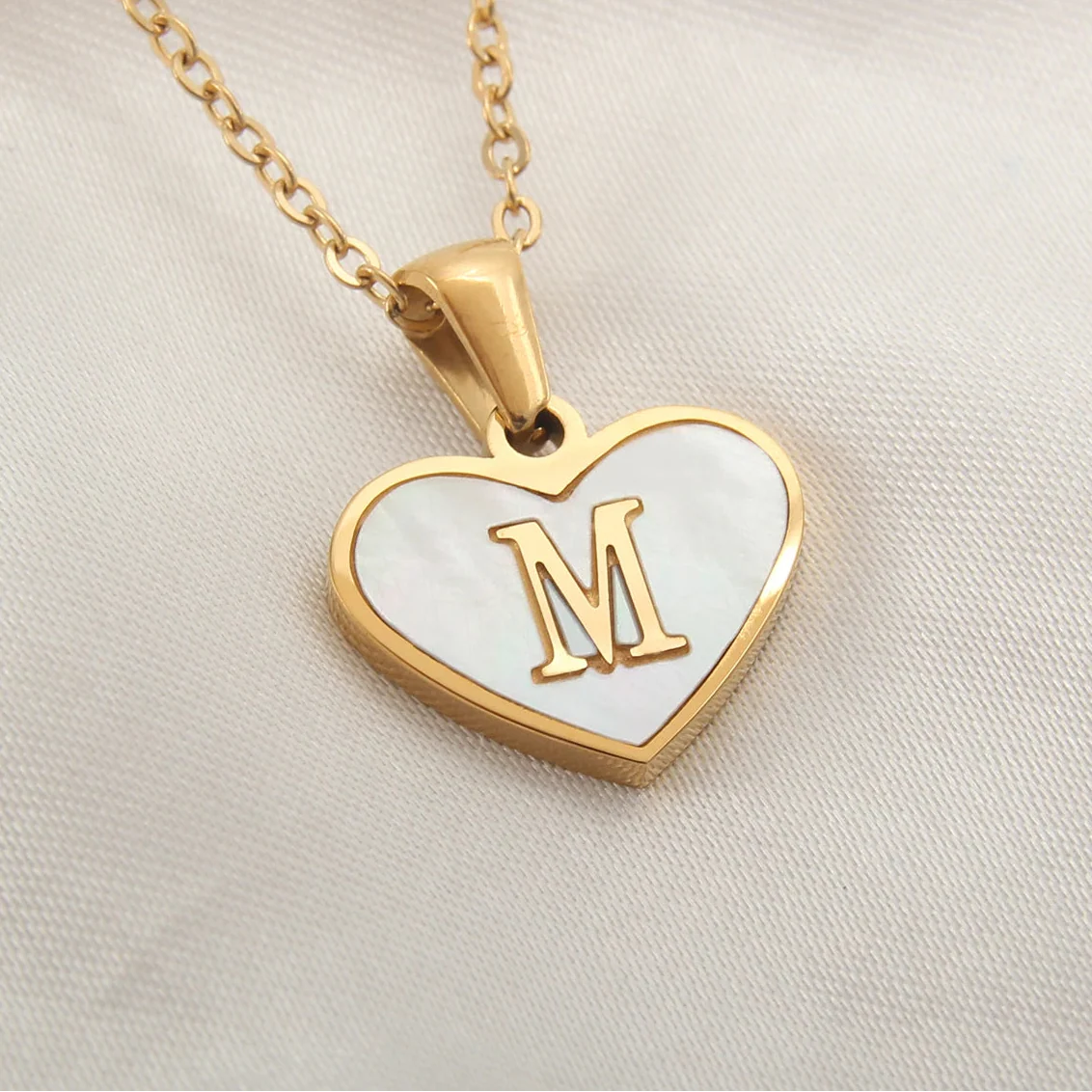 Necklace with white heart pendant initial m