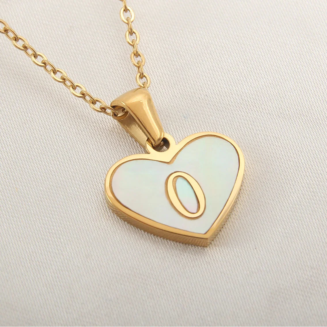 Necklace with white heart pendant initial o