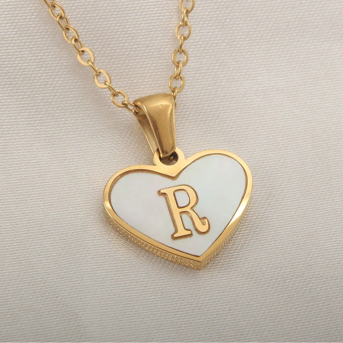 Necklace with white heart pendant initial r