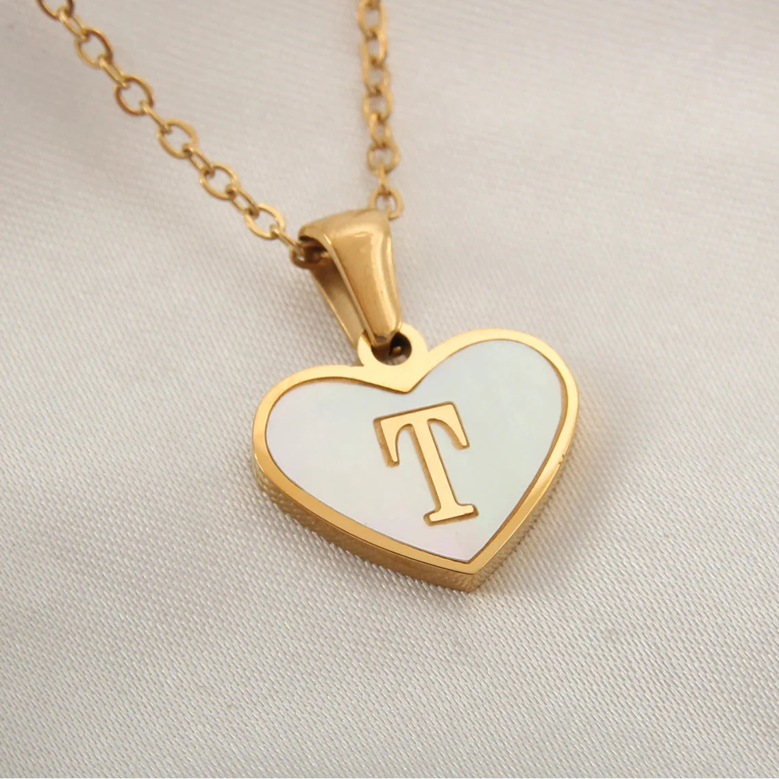 Necklace with white heart pendant initial t