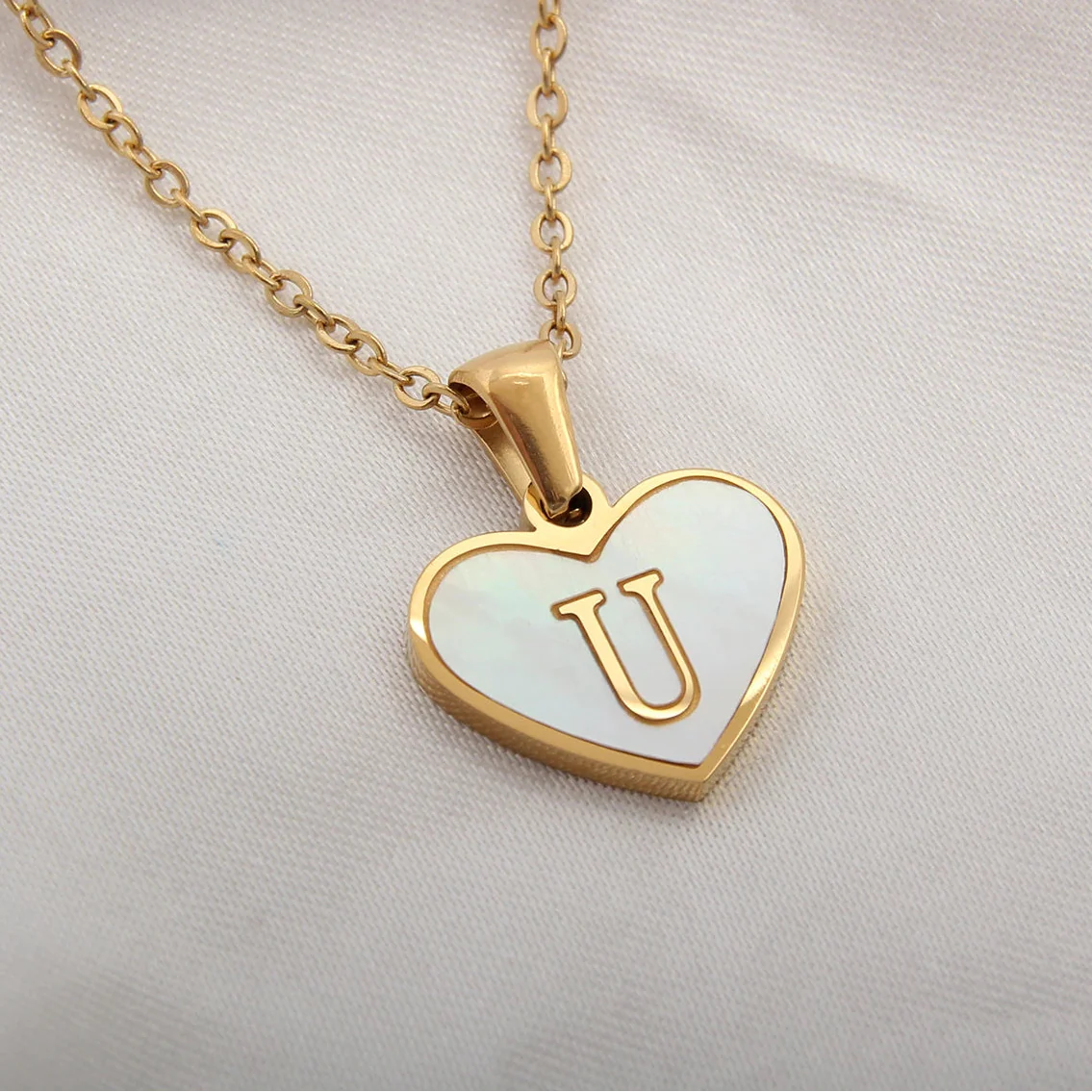 Necklace with white heart pendant initial u
