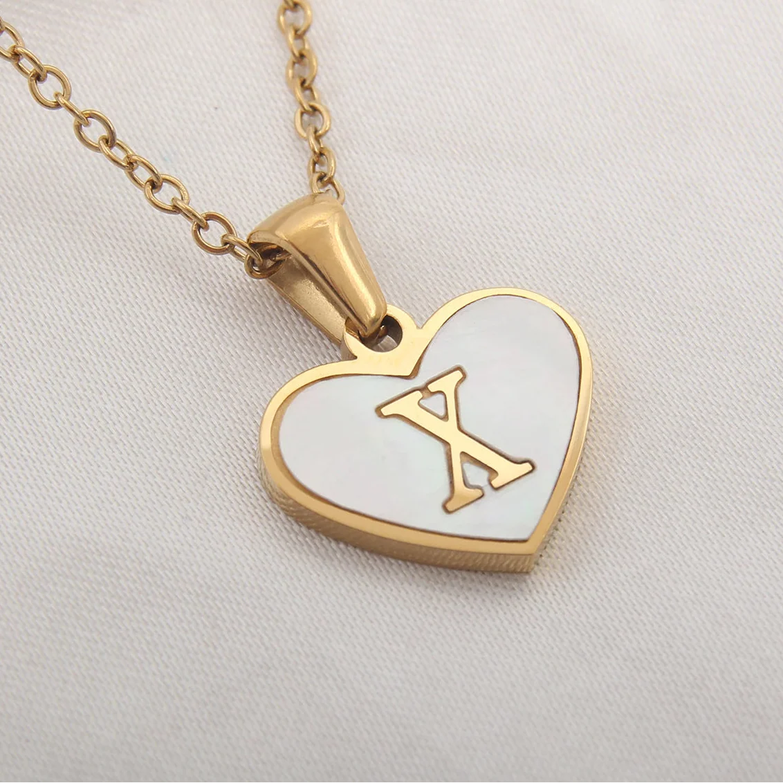 Necklace with white heart pendant initial x