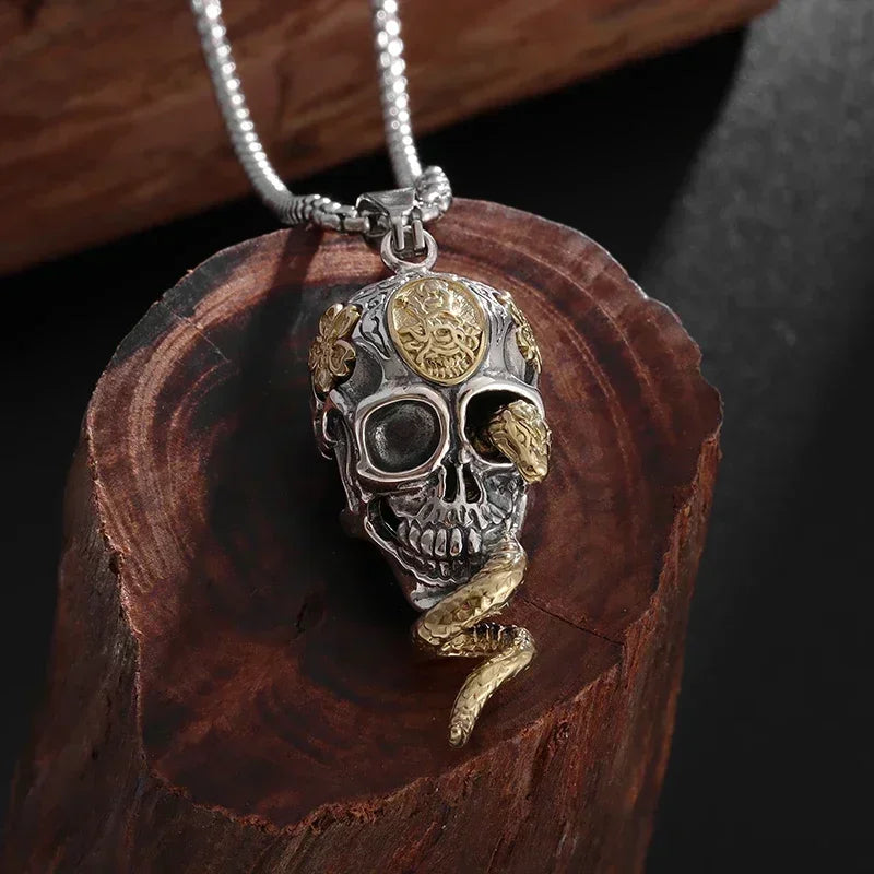 Necklace with symbolic skull and snake pendant