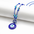 Collier en corde avec grand pendentif oeil bleu