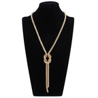 Lange ketting met knoop-hanger in goud