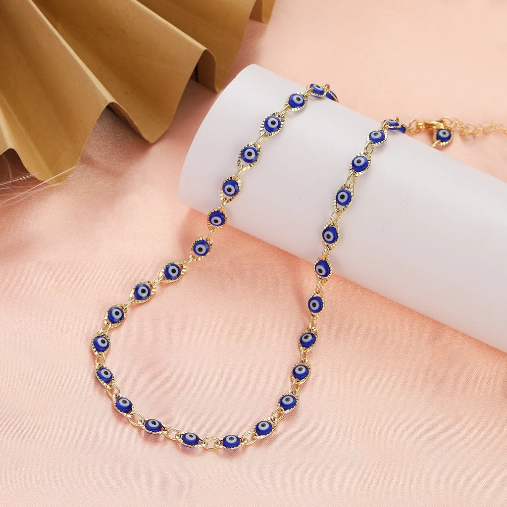 Collier ras de cou orné de multiples pendentifs oeil bleu bleu foncé