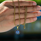 Collier torsadé avec pendentif oeil bleu discret or